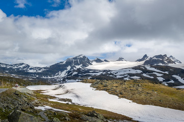 Fototapeta na wymiar Road in the snowy rocky mountains, Norway.