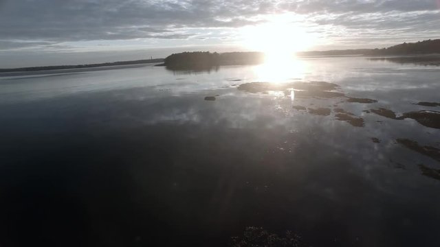 Sunset over the Casco Bay in Maine with a flock of birds