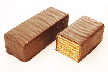 Two sweet chocolate coated waffles sliced half portion