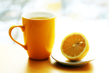 Bright yellow cup of tea and kemon