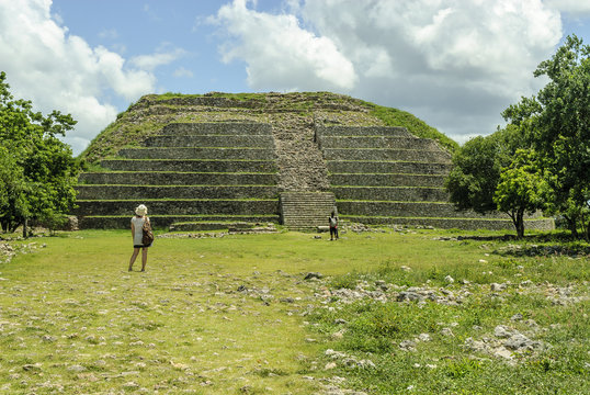 tourists observing the ruins of the big pyramid Kinich kakmo of the city of Izamal in Yucatan, Mexico