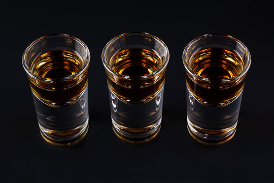 Three shots with cognac or jager on black