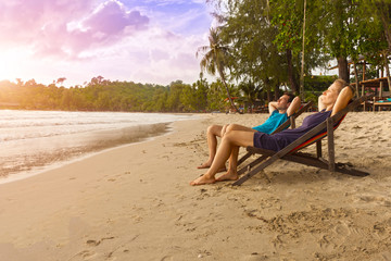 happy couple enjoy luxury sunset on the beach during summer vacations