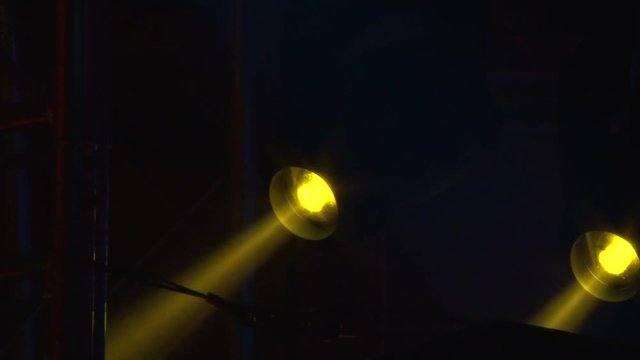 Light at the concert. Stroboscopes shine, colorful light.

