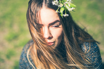 Sensual dreamy portrait of a spring woman, beautiful face female enjoying Cherry blossom, tree branch and natural beauty