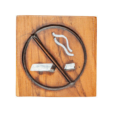 No smoking sign made from wooden carving with white background.