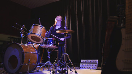 Fototapeta na wymiar Teen rock music - Passionate dashing girl percussion drummer perform music break down
