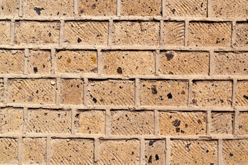 A brick wall built of bricks of the Armenian tuff