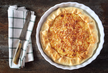 Onion cheese tart on wooden table