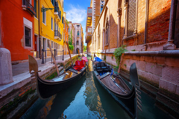 gondolas moored in narrow venetian canal