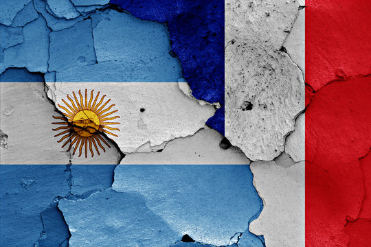 flags of Argentina and France painted on cracked wall