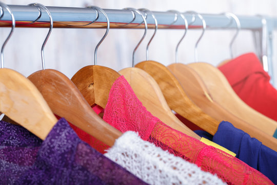 colorful womens clothes on hangers on rack in fashion store. wom