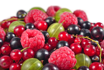 Various kinds of fresh berries close up on a white
