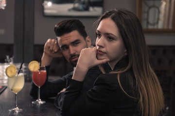 young man looking at woman, looking away