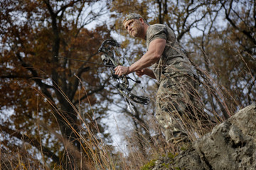Bow hunter on a hill