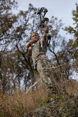 Bow hunter on a hill