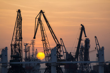 Industrial port dockyard with sunset