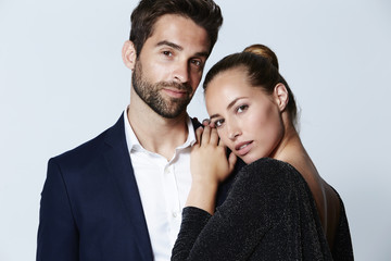 Brunette couple posing for camera in studio