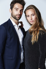 Good looking couple looking at camera, studio
