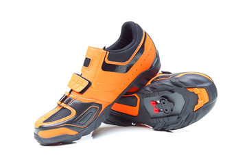 Mountain bike cycling shoes in orange color isolated