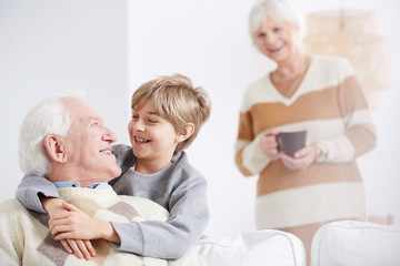 Boy embracing his grandfather