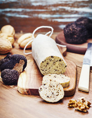 Obraz na płótnie Canvas Homemade aromatic butter with black truffles on wooden board.Selective focus.