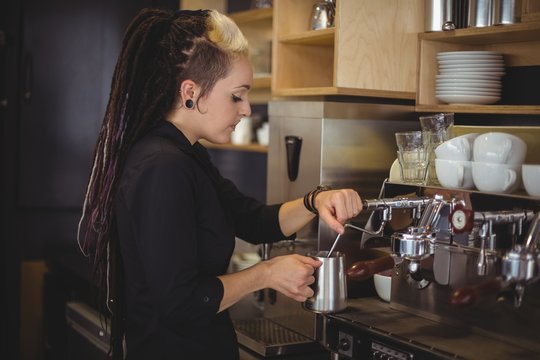 Waitress using the coffee machine