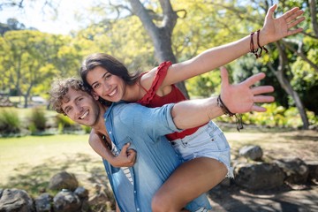 Man giving a piggyback ride to woman