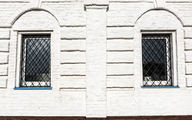 2 windows on white brick wall