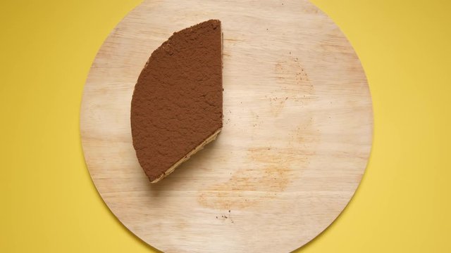 TOP VIEW: Eating a layer cake on a yellow background - Stop motion