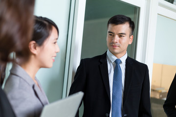 Group of business people discuss together