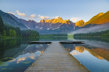 sunrise over the crystal-clear mountain lake in the Julian Alps