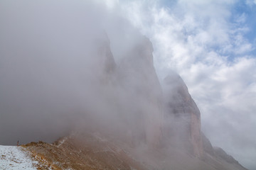 Tre Cime di Lavaredo in beautiful surroundings in the Dolomites at foggy weather (Drei Zinnen)
