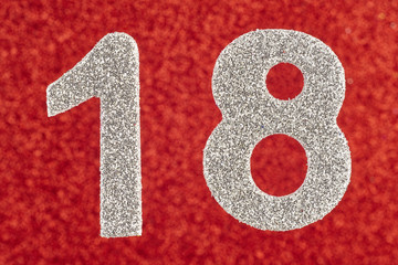 Number eighteen silver color over a red background. Anniversary.