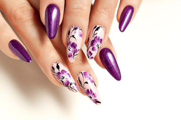 Nail art service. Female manicure and floral patterns.