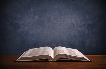 Open Bible on a wood desk