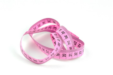 pink measuring tape isolated. conceptual.
