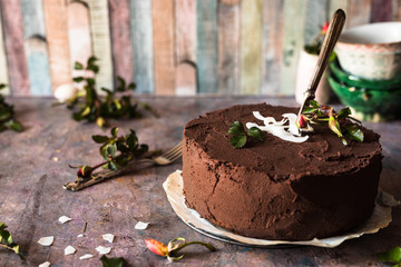 torta vegana al cioccolato fondente e cocco con coltello per il taglio di una fetta; immagine orizzontale - obrazy, fototapety, plakaty