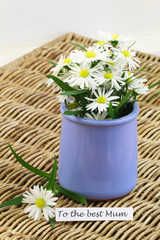To the best Mum card with white daisies in blue vase on wicker surface
