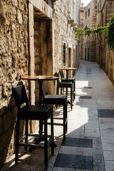 Fototapeta na wymiar Chair and table of the restaurant on a narrow European street in the historic city.