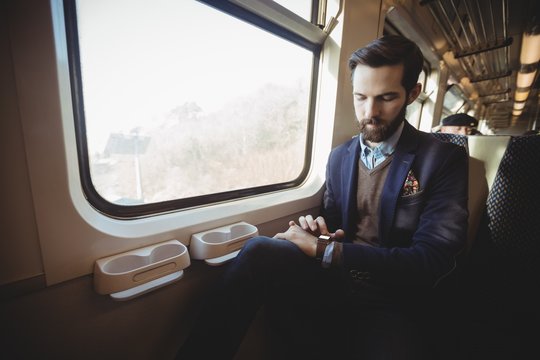 Businessman checking using smartwatch while travelling