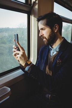Businessman taking picture from mobile phone while travelling