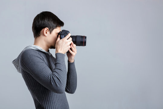 profile portrait of successful professional photographer use DSL