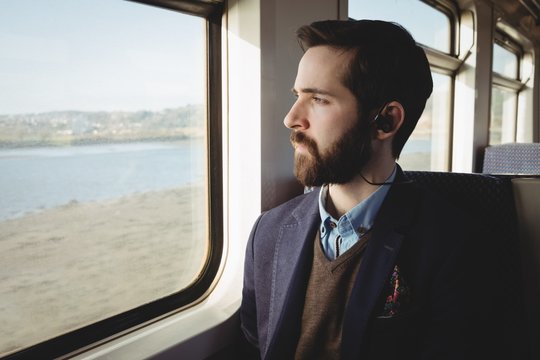 Businessman looking out through train window