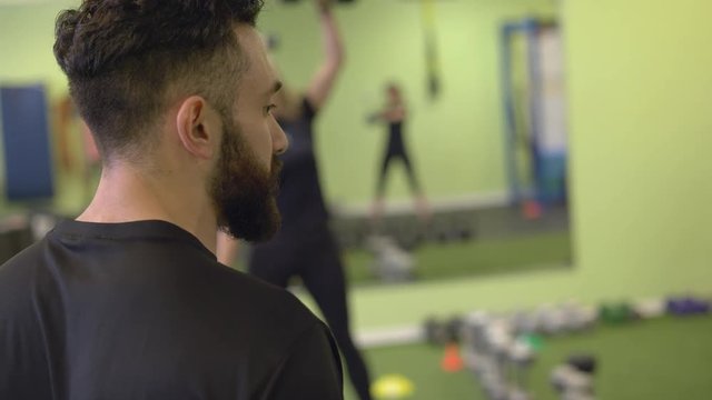 A male coach urging clients to keep going