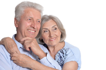 Happy old couple embracing on a white background