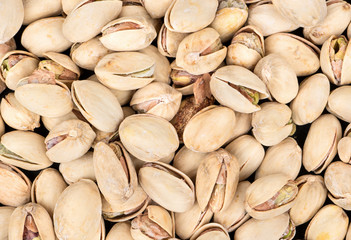 Background of salted pistachio nuts close up