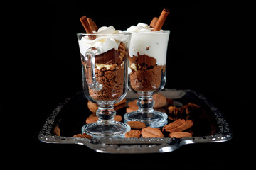 Sweet dessert with chocolate, cocoa, nuts and whipped cream