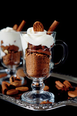 Sweet dessert with chocolate, cocoa, nuts and whipped cream