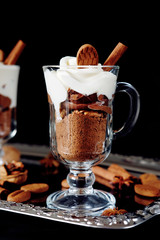 Sweet dessert with chocolate, cocoa, nuts and whipped cream